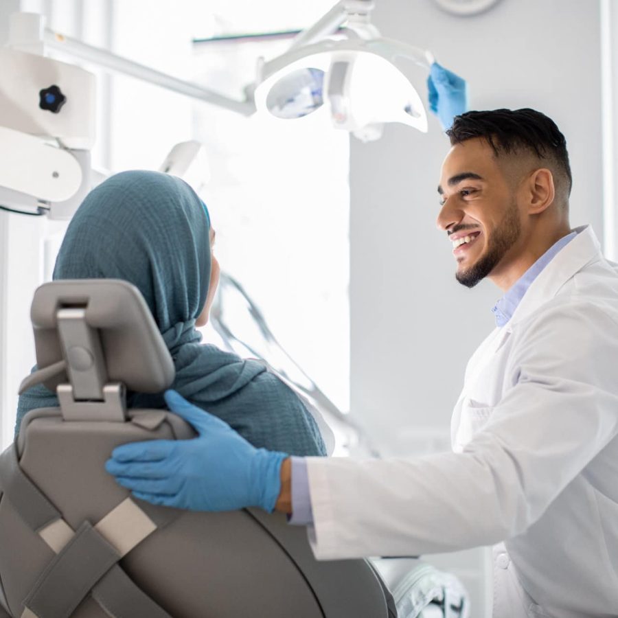 Dental Treatment. Dentist Doctor Making Check Up To Female Patient