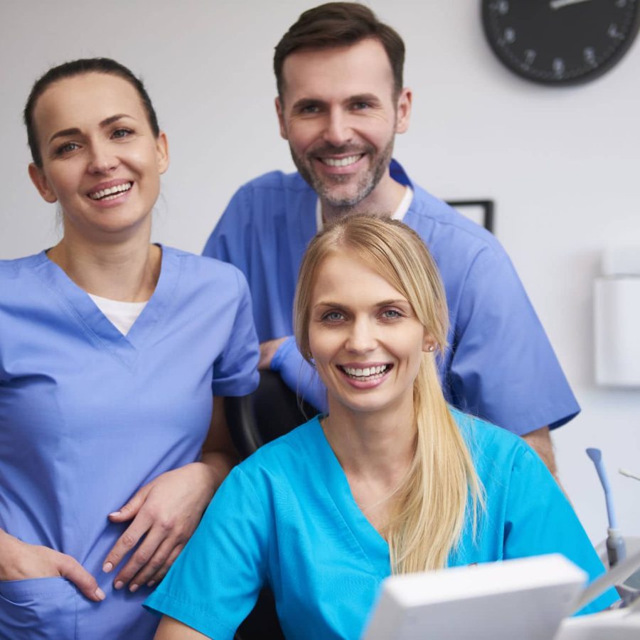 Team of happy stomatologists in dentist's clinic